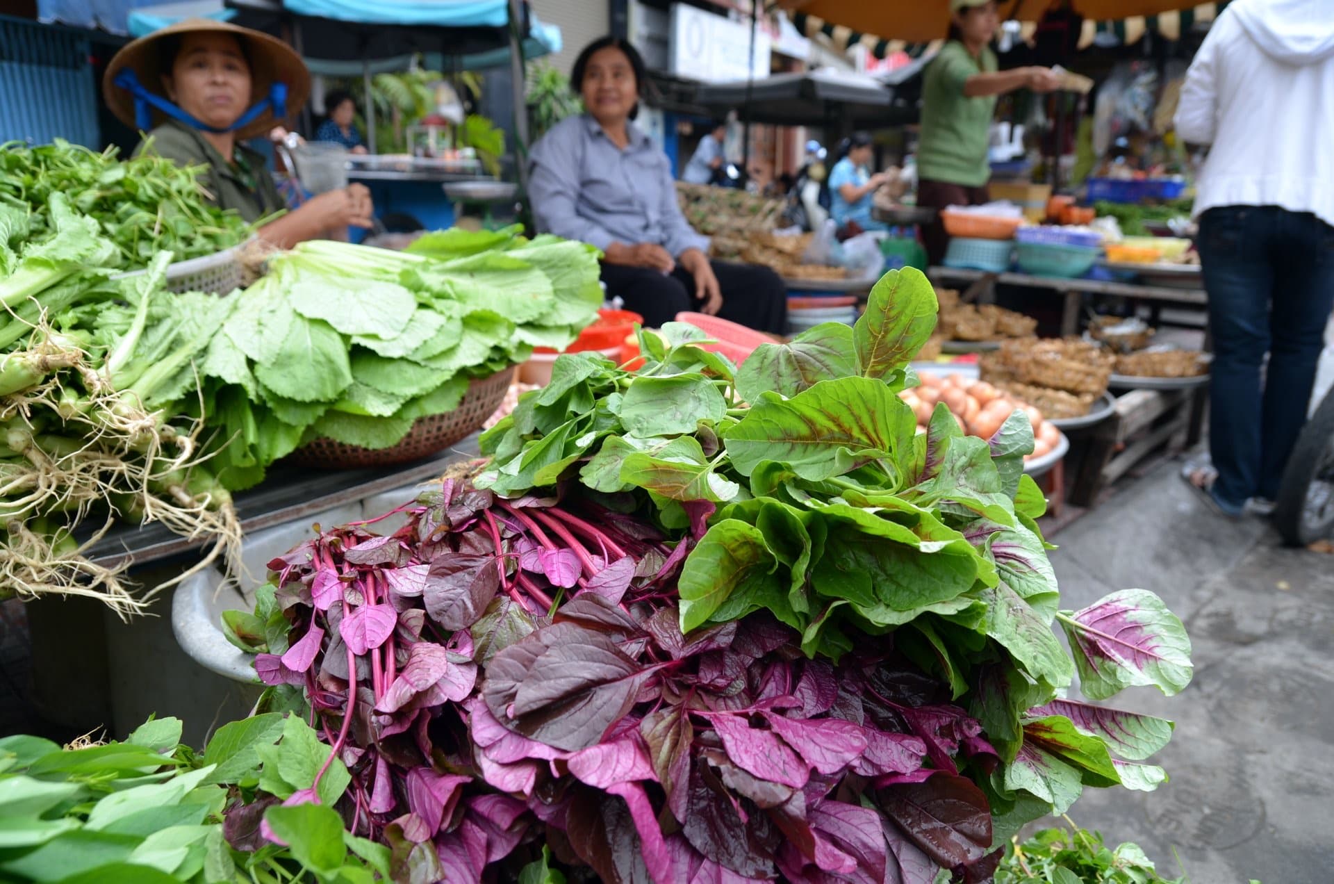 Fresh leafy greens at a Vietnamese morning market stall